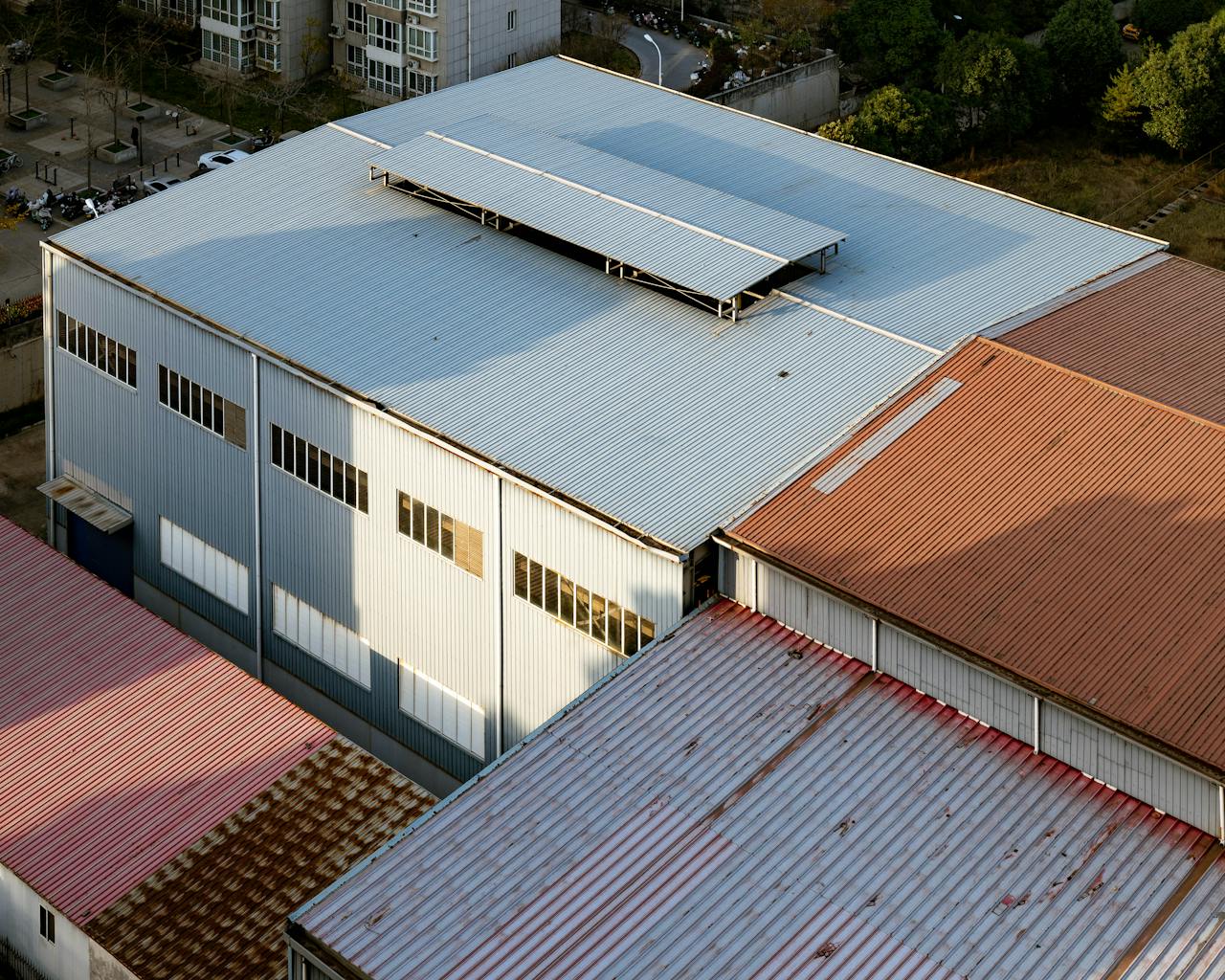 Aerial shot showcasing industrial building roofs with varying colors in Luoyang, China.